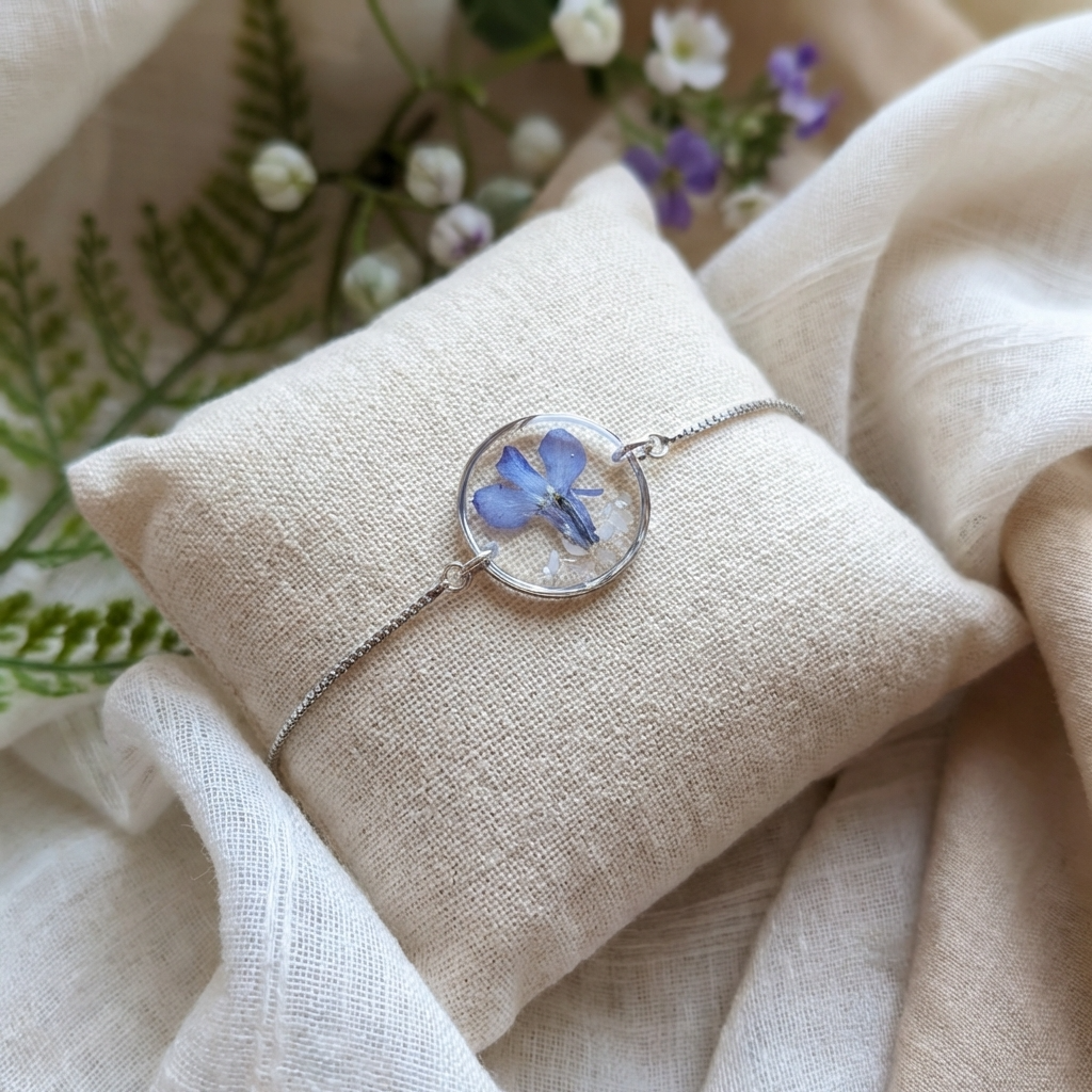 Blue lobelia 20mm flat bracelet with seashell flakes on jewellery display stand, handmade real flower jewellery by Work by Nature