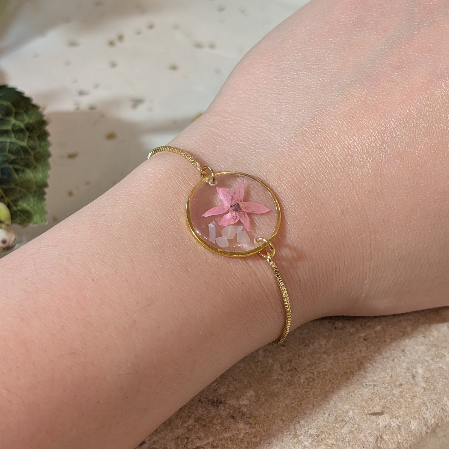 Pink Borage on seashell flakes Adjustable Bracelet on hand