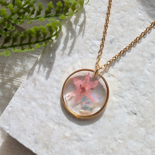 Pink chive blossom 20mm flat necklace with seashell flakes on jewellery display stand, handmade real flower jewellery by Work by Nature
