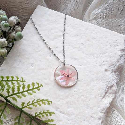 Pink chive blossom 20mm flat stainless steel necklace with seashell flakes on jewellery display stand, handmade real flower jewellery by Work by Nature