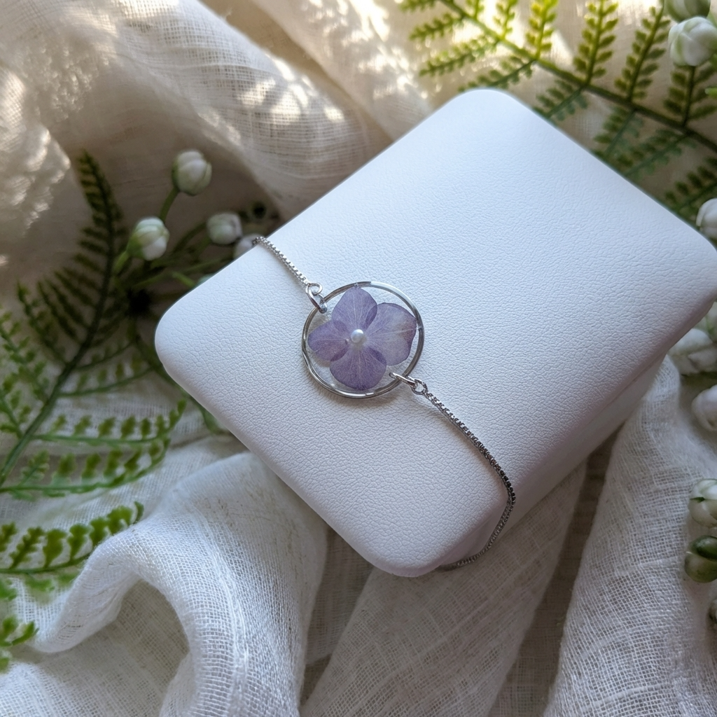 Purple hydrangea 20mm flat bracelet with imitation pearl on jewelry display stand, handmade real flower jewelry by Work by Nature