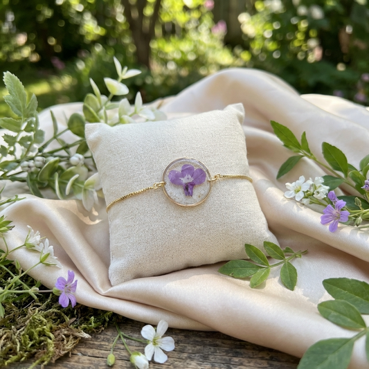 Purple lobelia 20mm flat bracelet with seashell flakes on jewellery display stand, handmade real flower jewellery by Work by Nature