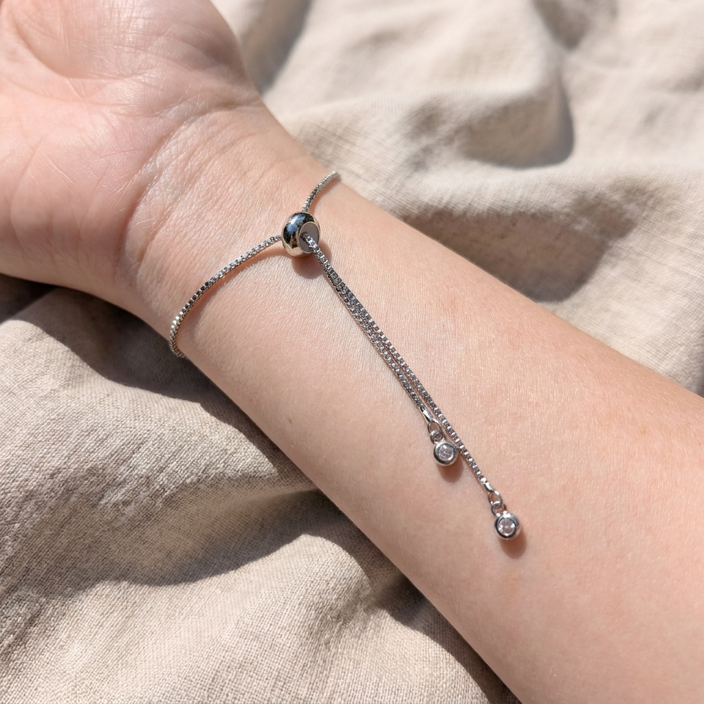 Close-up of the adjustable slider mechanism on a platinum plated purple lobelia bracelet, showing the bracelet fastening and fit detail