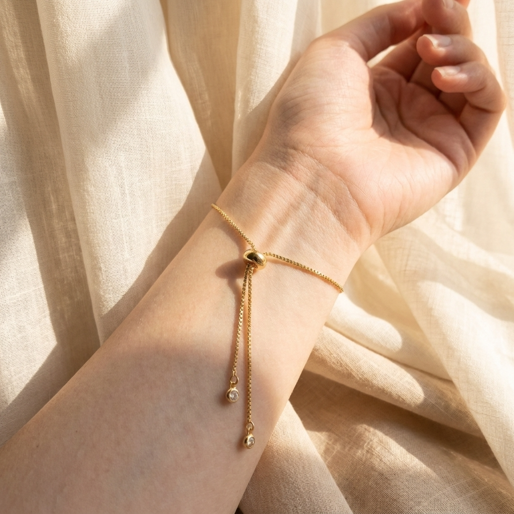 Close-up of the adjustable slider mechanism on a gold plated Queen Anne’s Lace bracelet, showing the bracelet fastening and fit detail