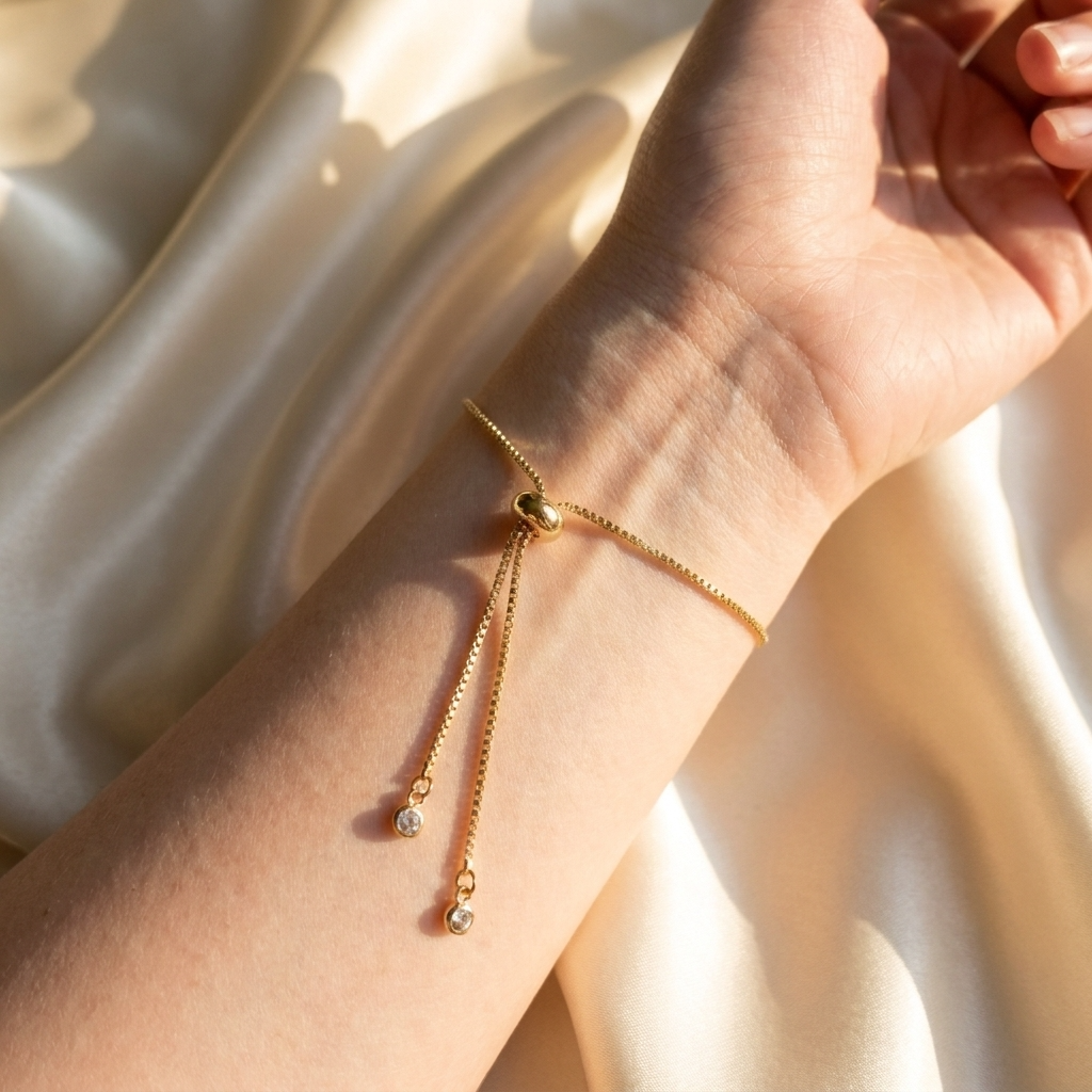 Close-up of the adjustable slider mechanism on a gold plated white lobelia bracelet, showing the bracelet fastening and fit detail